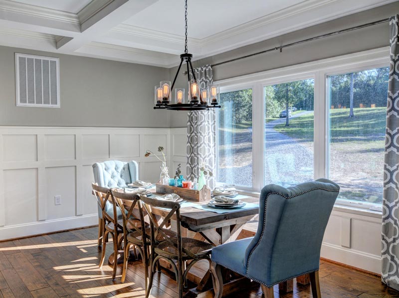 Dining table with chairs next to the window