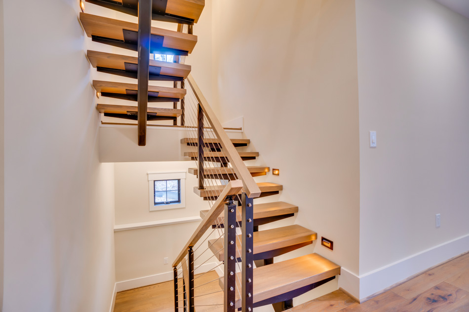 Wood staircase with metal railings design